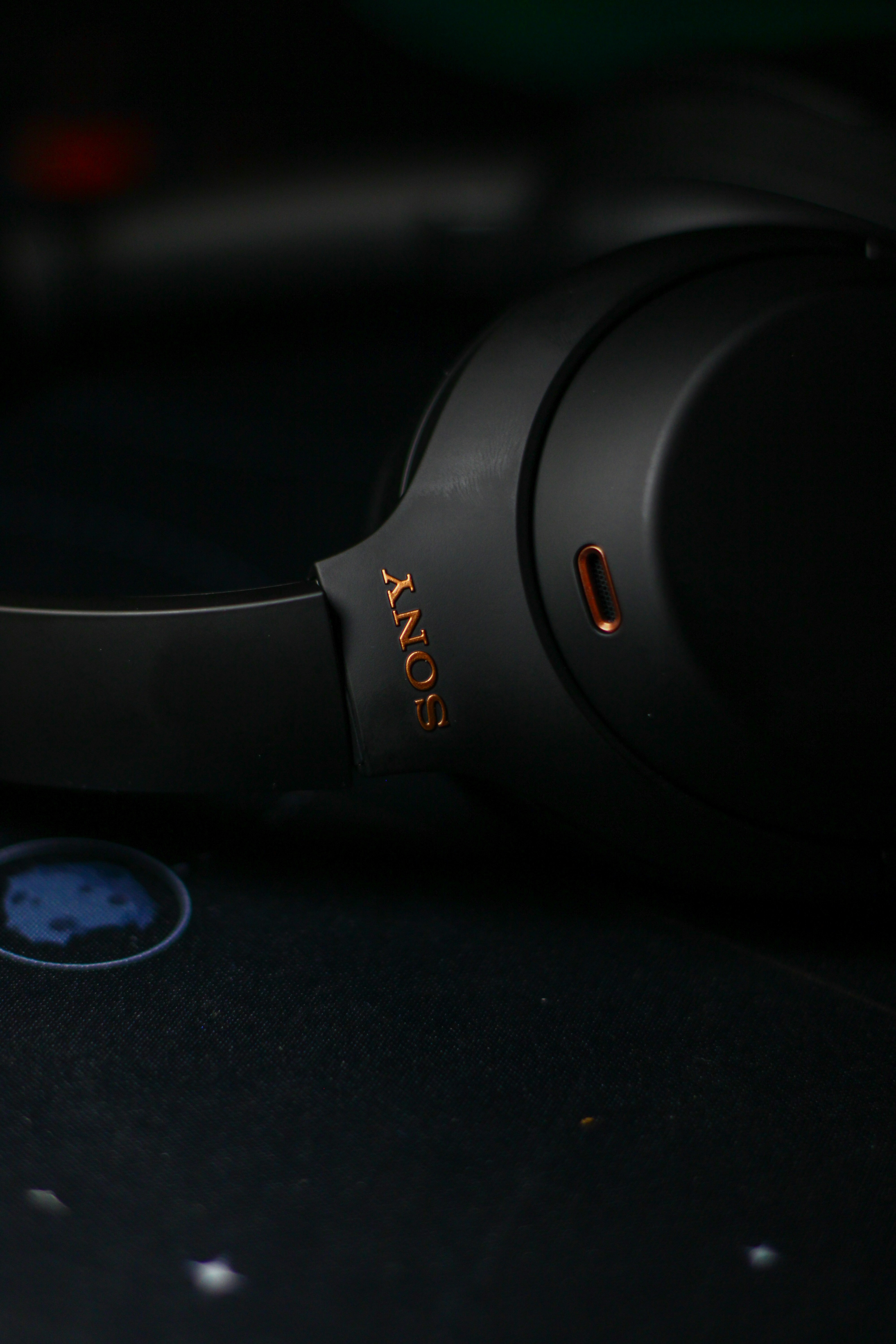 Black sony headphones on a dark textured surface