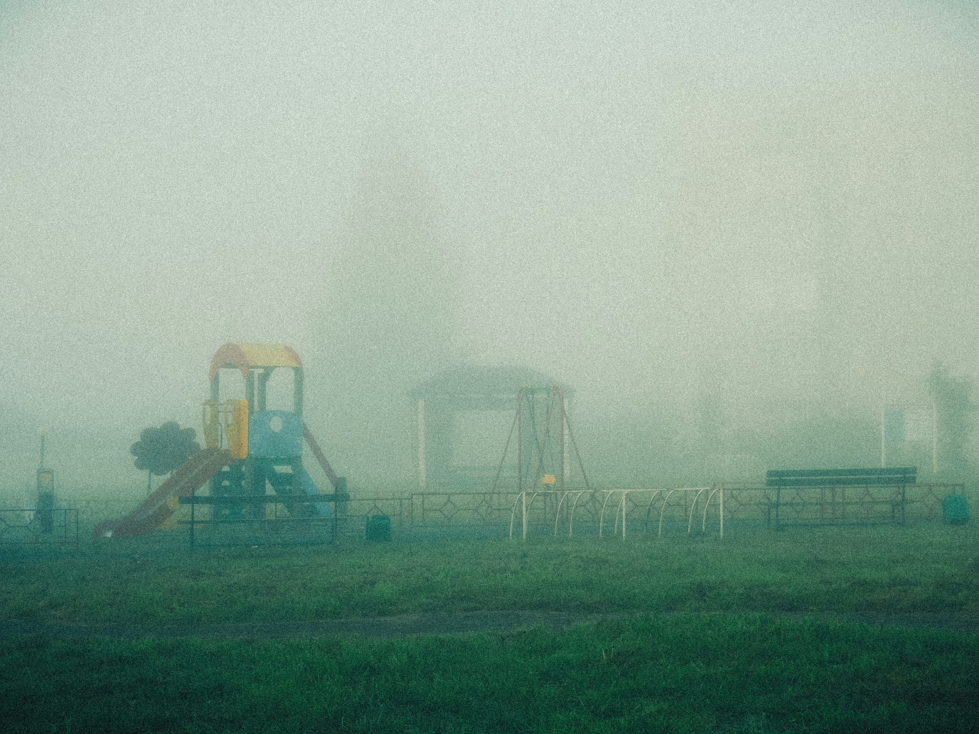 Playground equipment shrouded in thick fog