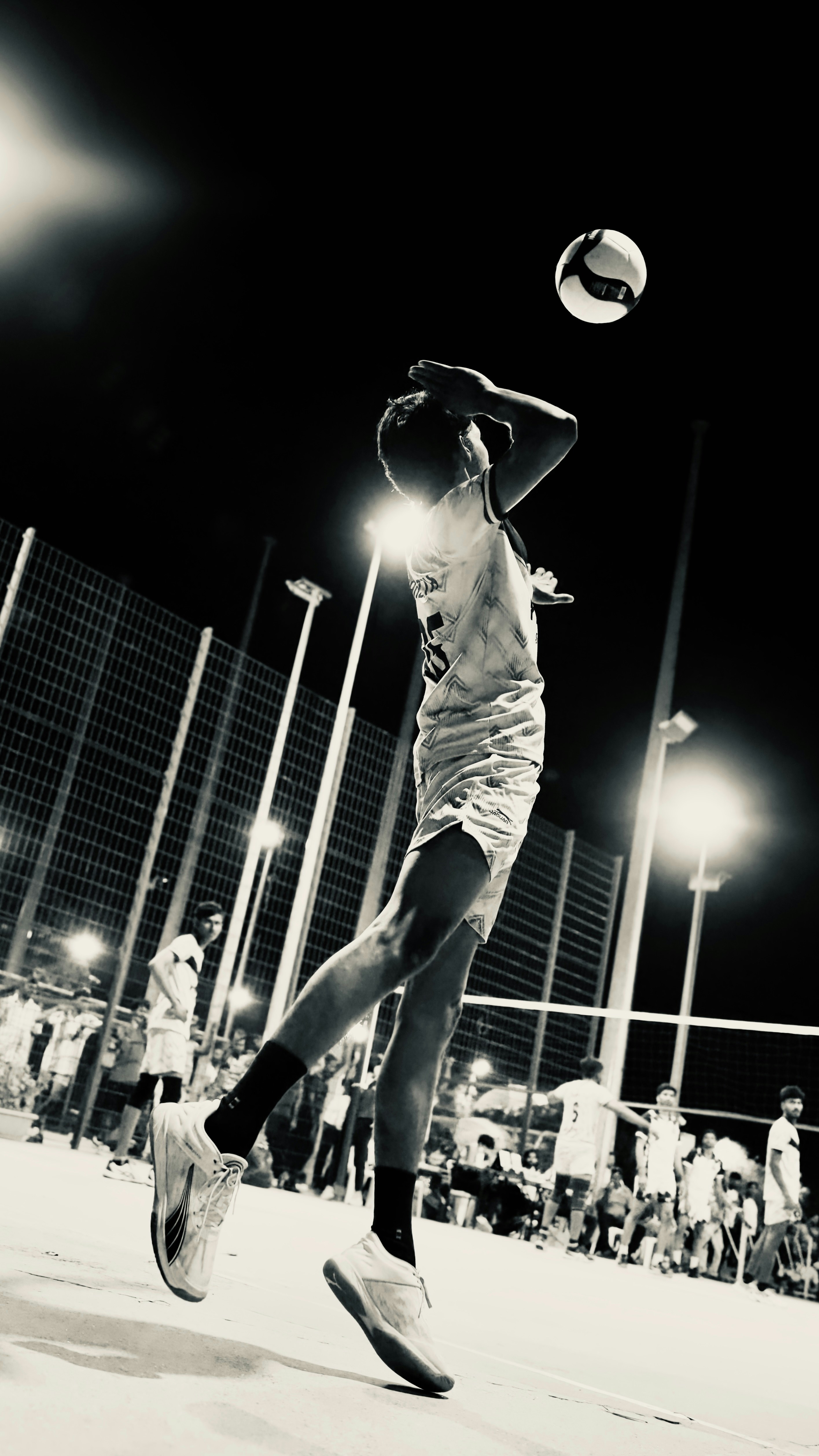 Volleyball player executing a jump serve