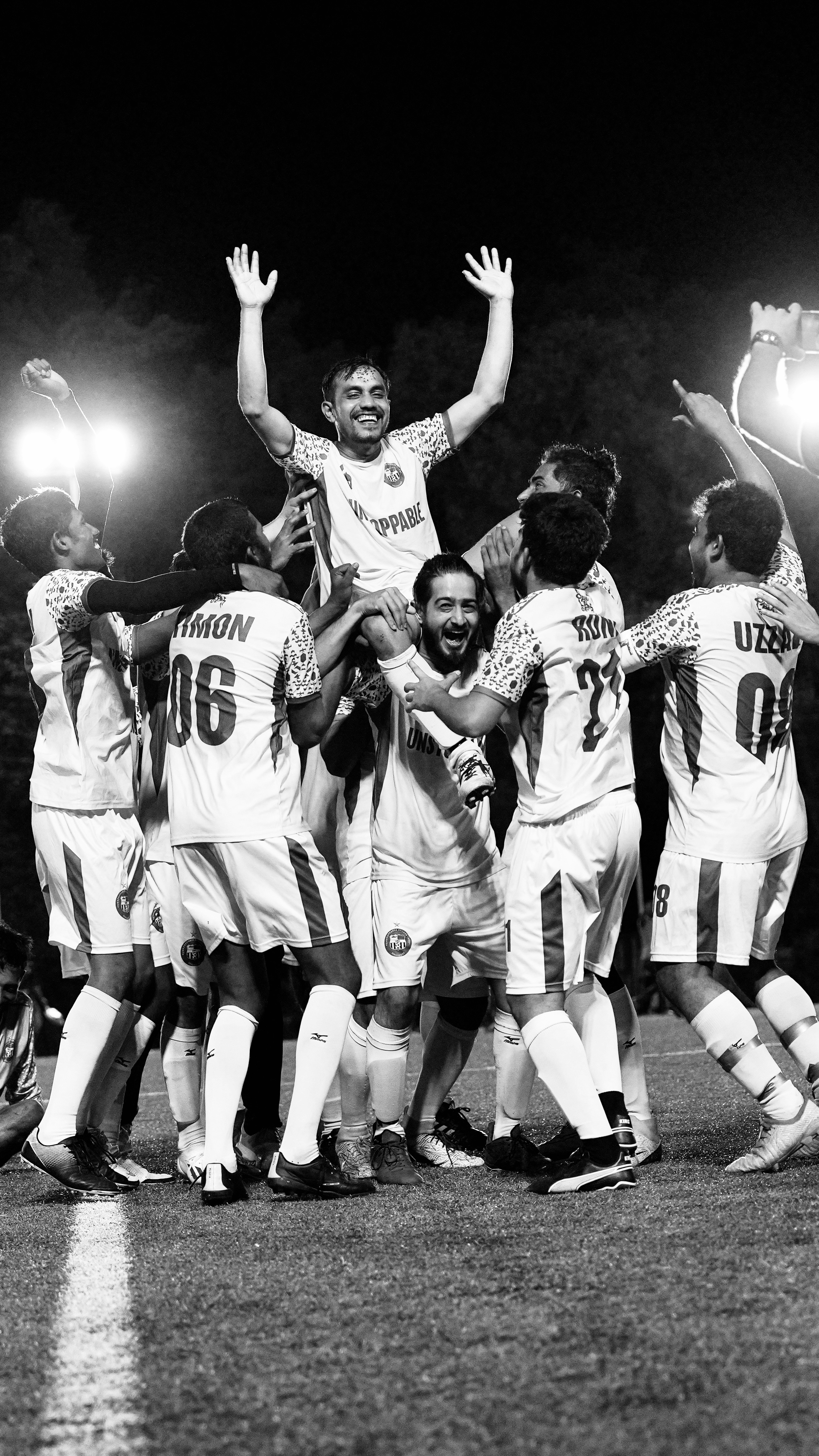 Football team celebrates victory, carrying player on shoulders. photo ...