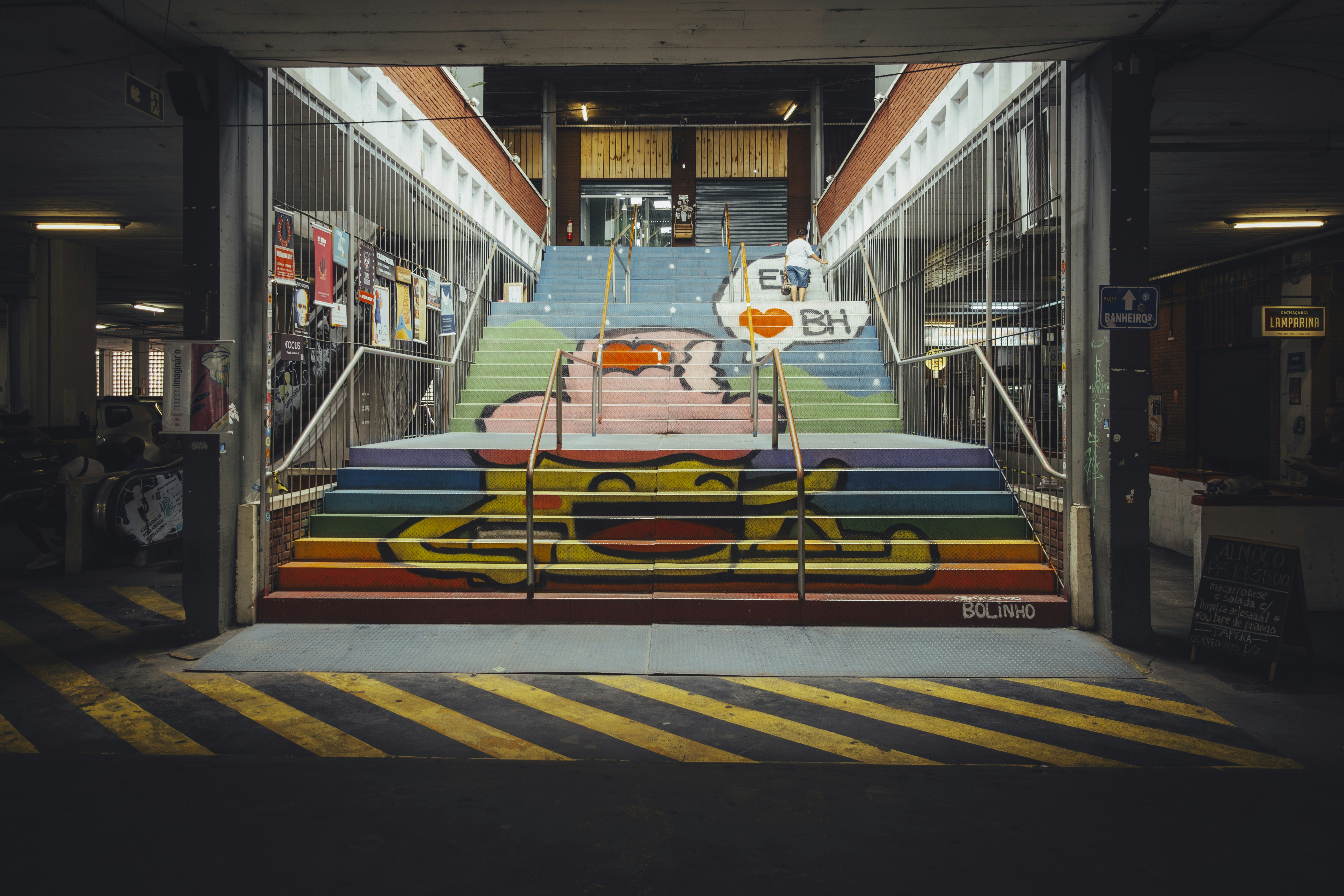 Colorful painted stairs with graffiti art inside a building.