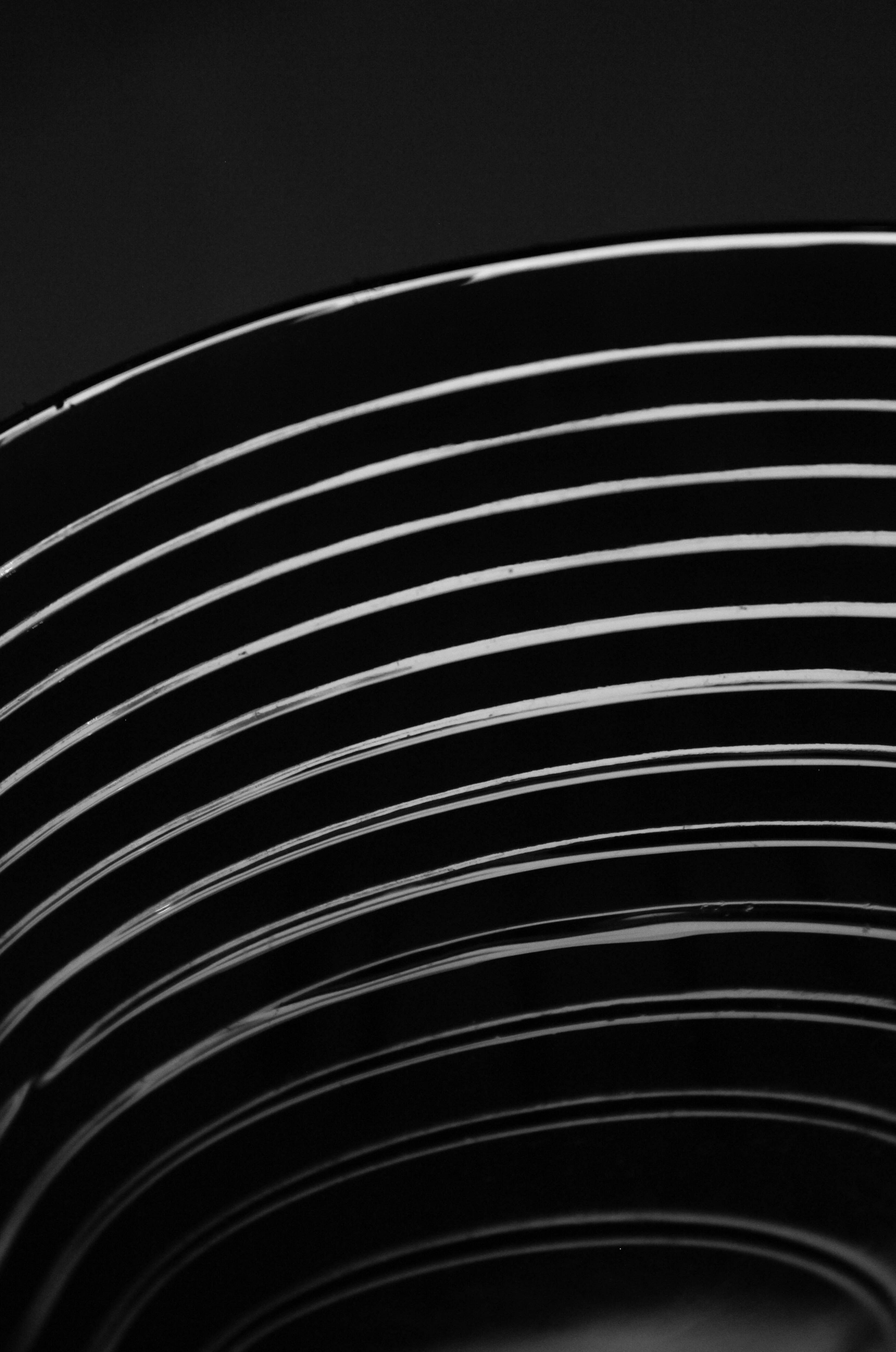 White curved waveform lines on black