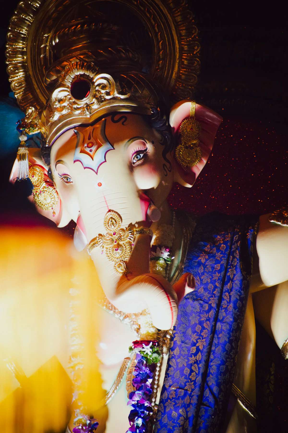 A close view of a festival Ganesha idol in silk and flowers