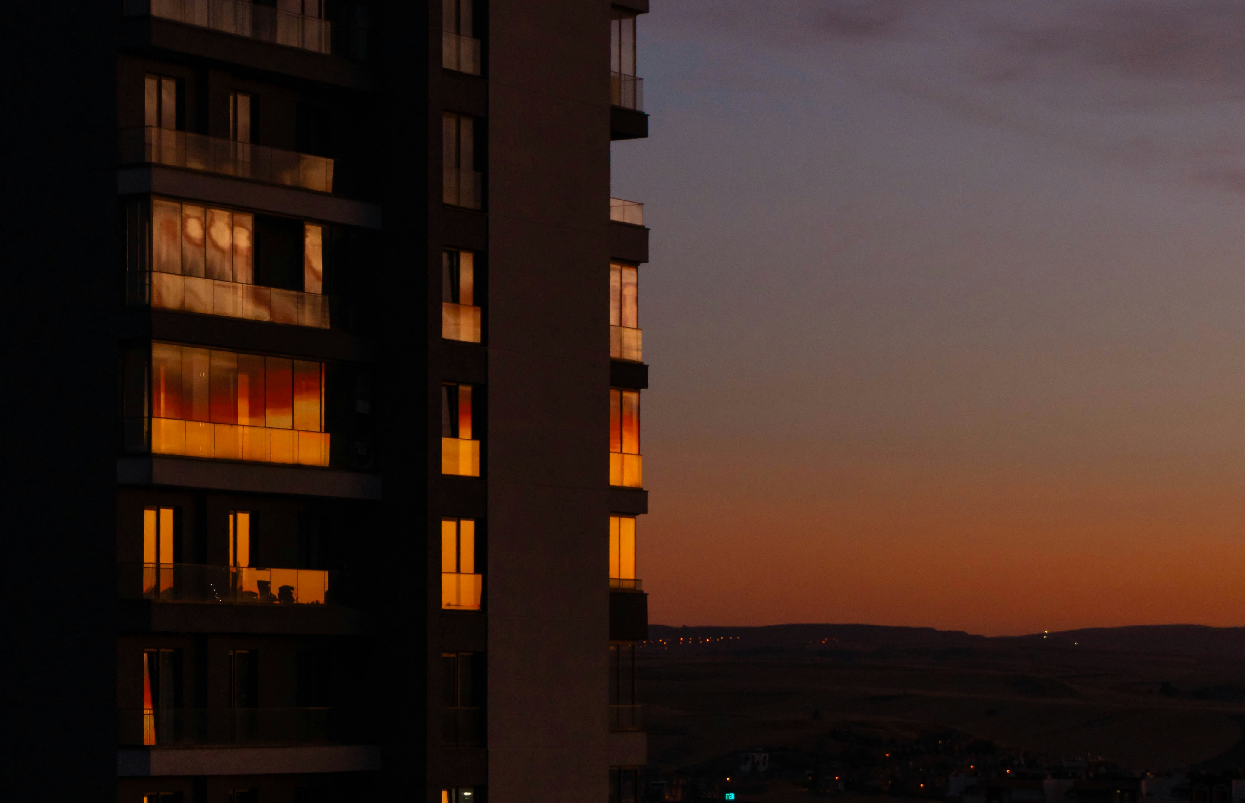 Modern building facade at sunset with warm light reflections. photo ...