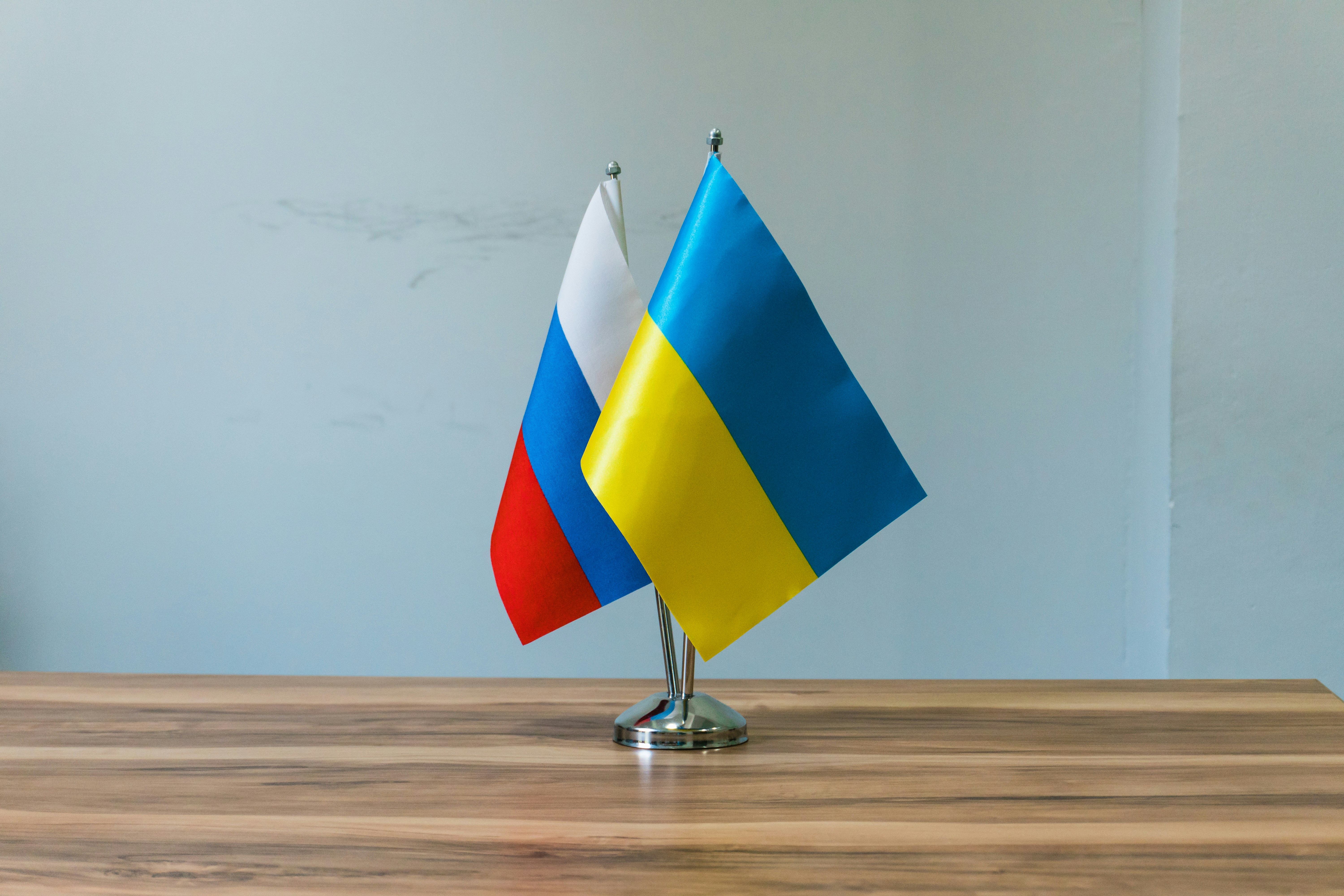 Russian and ukrainian flags on a table
