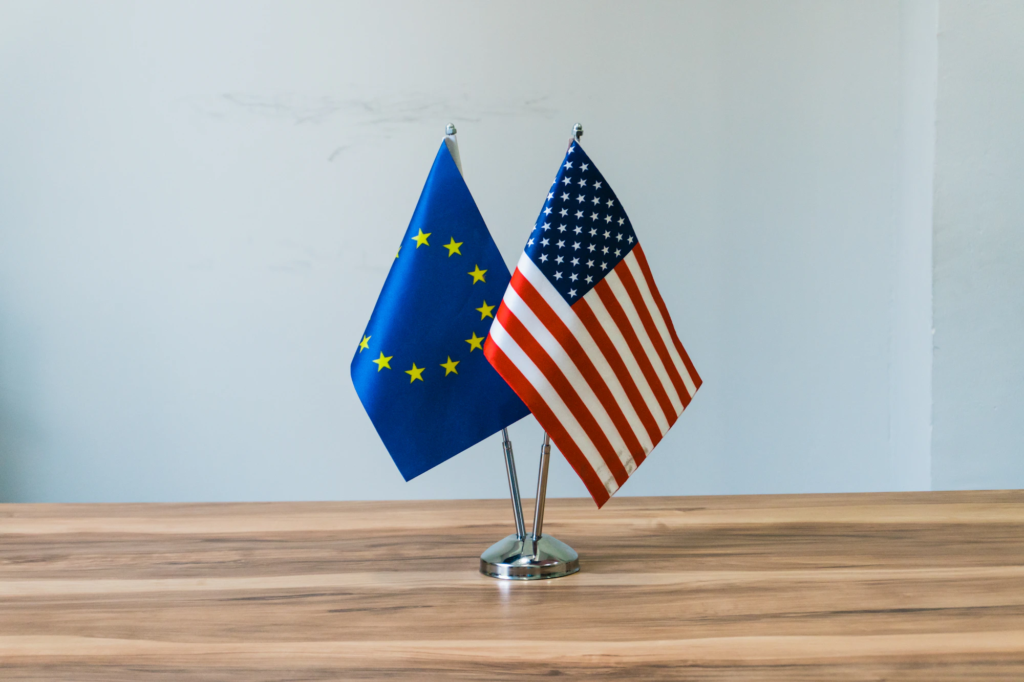 European Union and United States flags standing together, representing a bilateral tax treaty between two jurisdictions