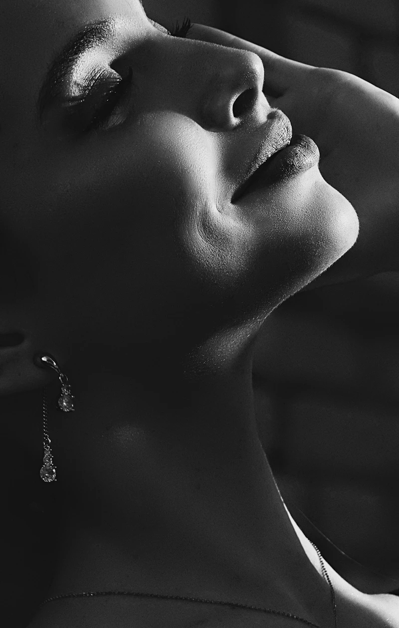 A black and white portrait with fine drop earrings
