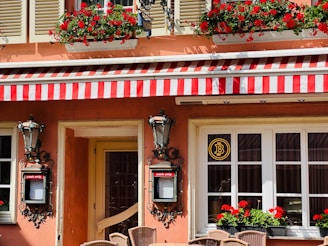 Exterior of a charming building with red flowers