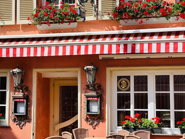 Exterior of a charming building with red flowers