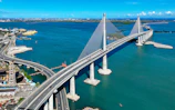 Modern cable-stayed bridge over blue ocean water