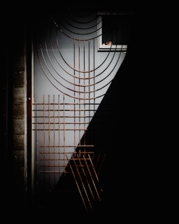 Rusty metal grate on a dark doorway