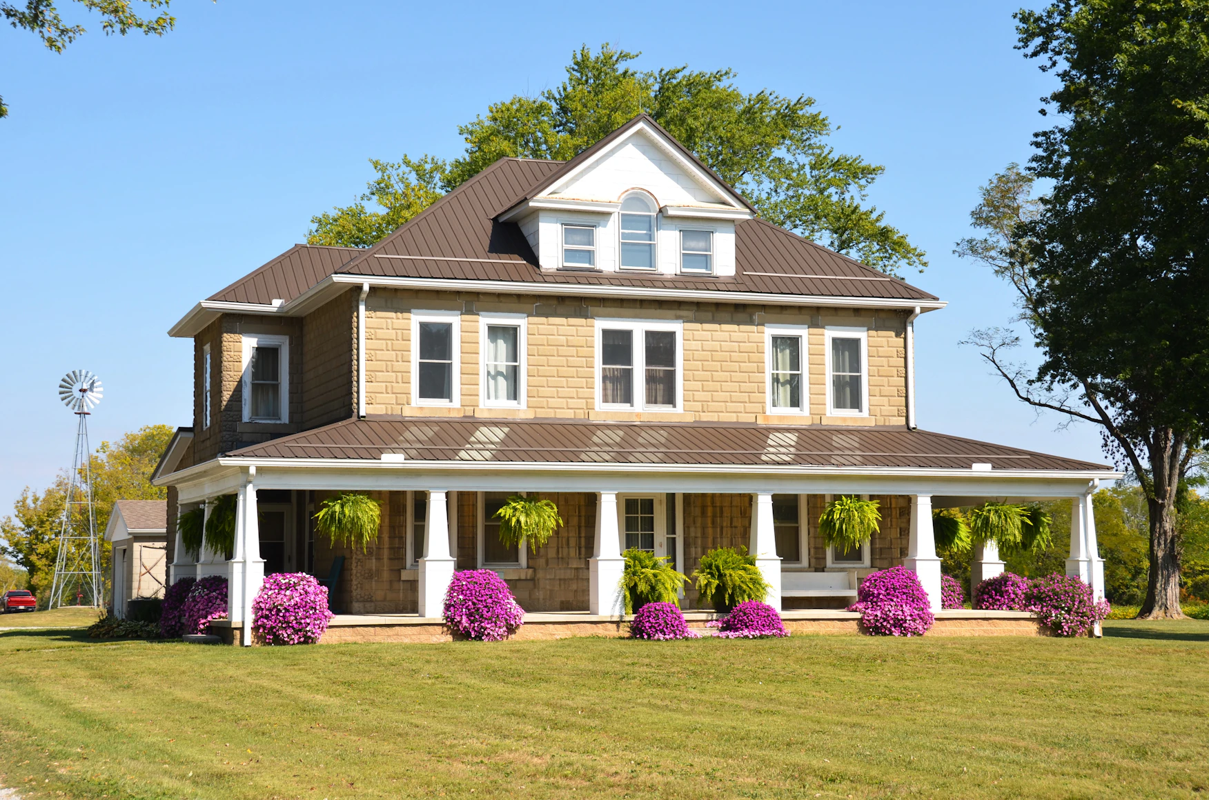 Beautiful blooming bougainvillea
    hedge along a farmhouse boundary