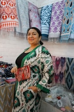 Woman in traditional patterned robe holding clutch