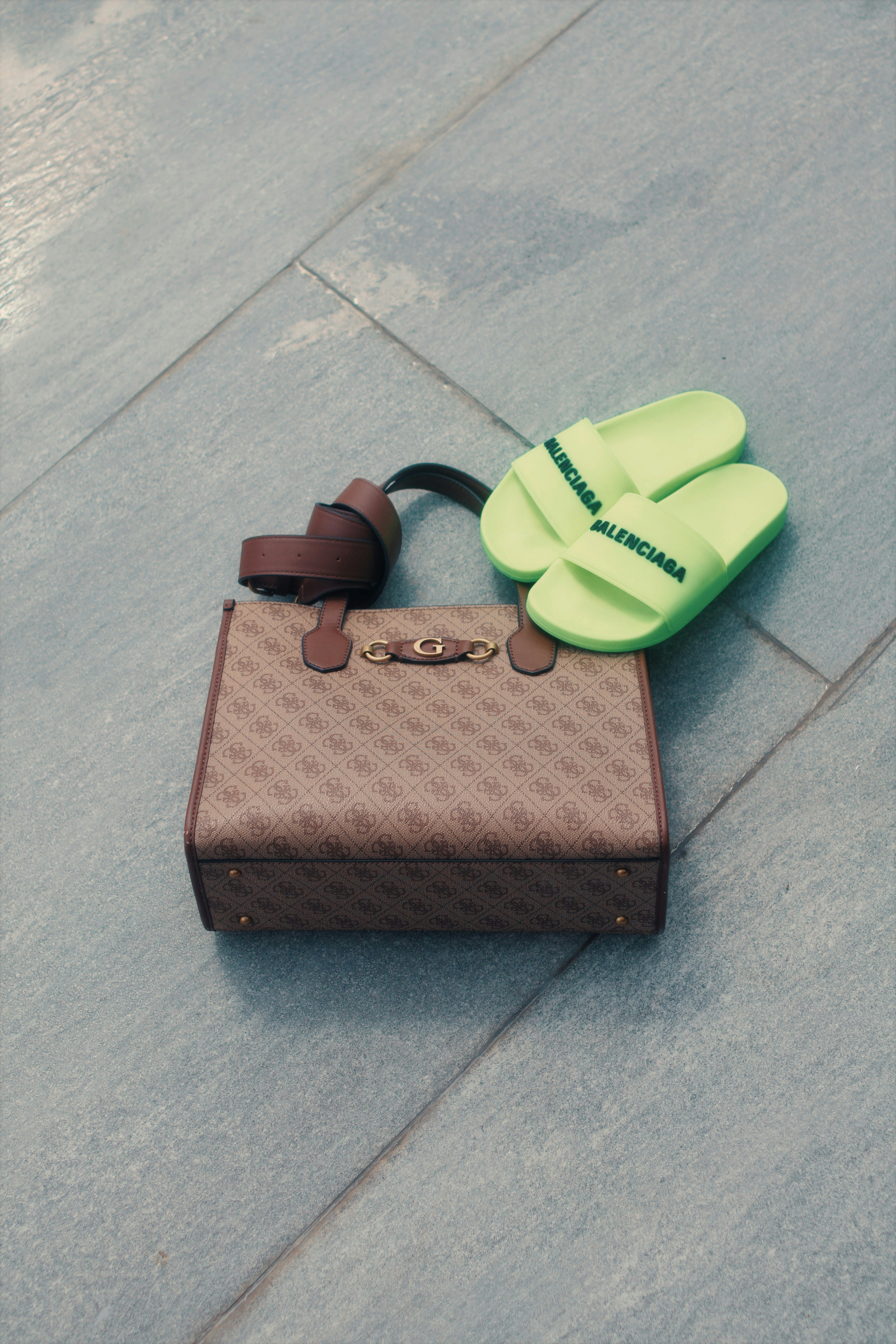 A patterned handbag with neon green slides