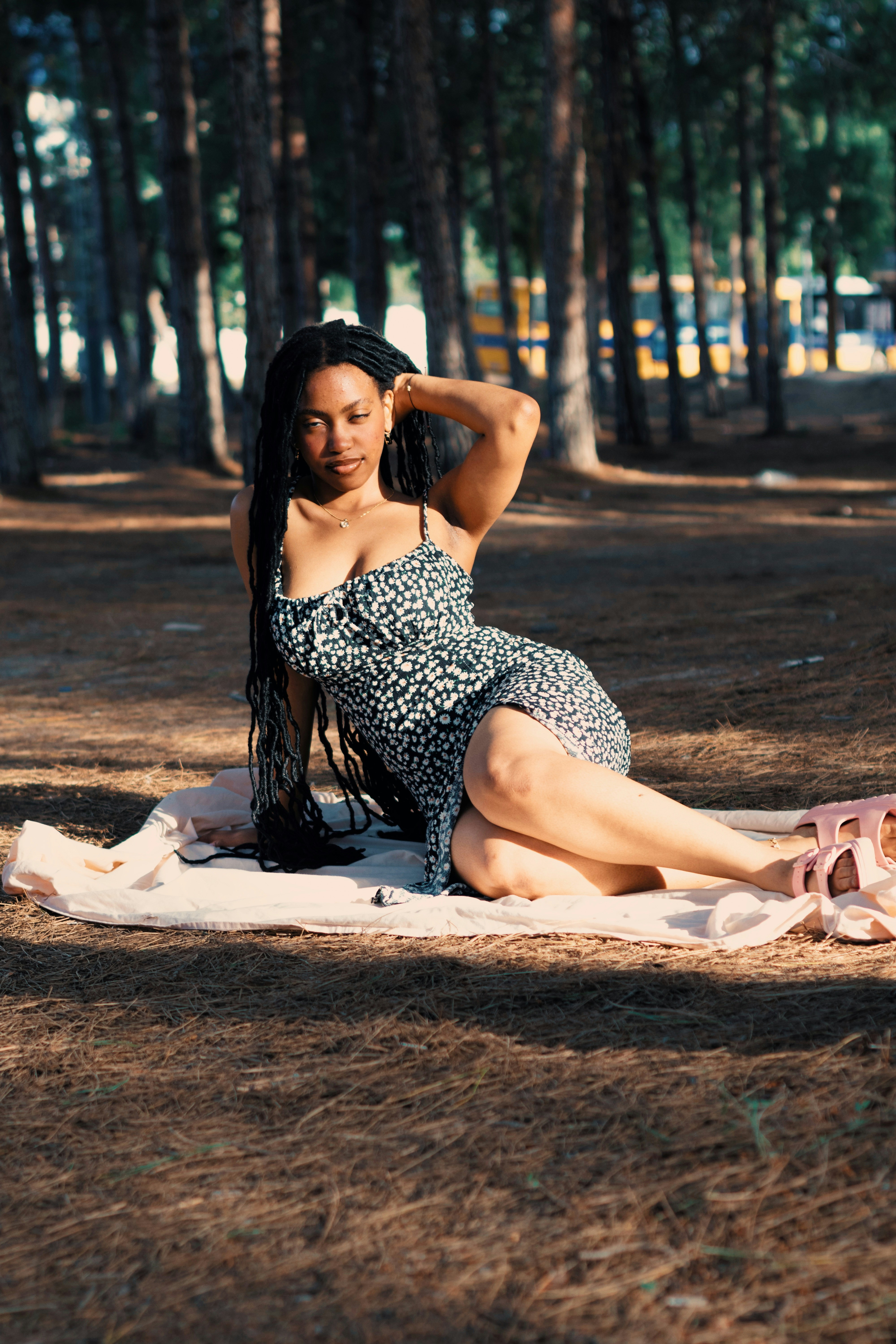 Woman posing on a blanket in a forest