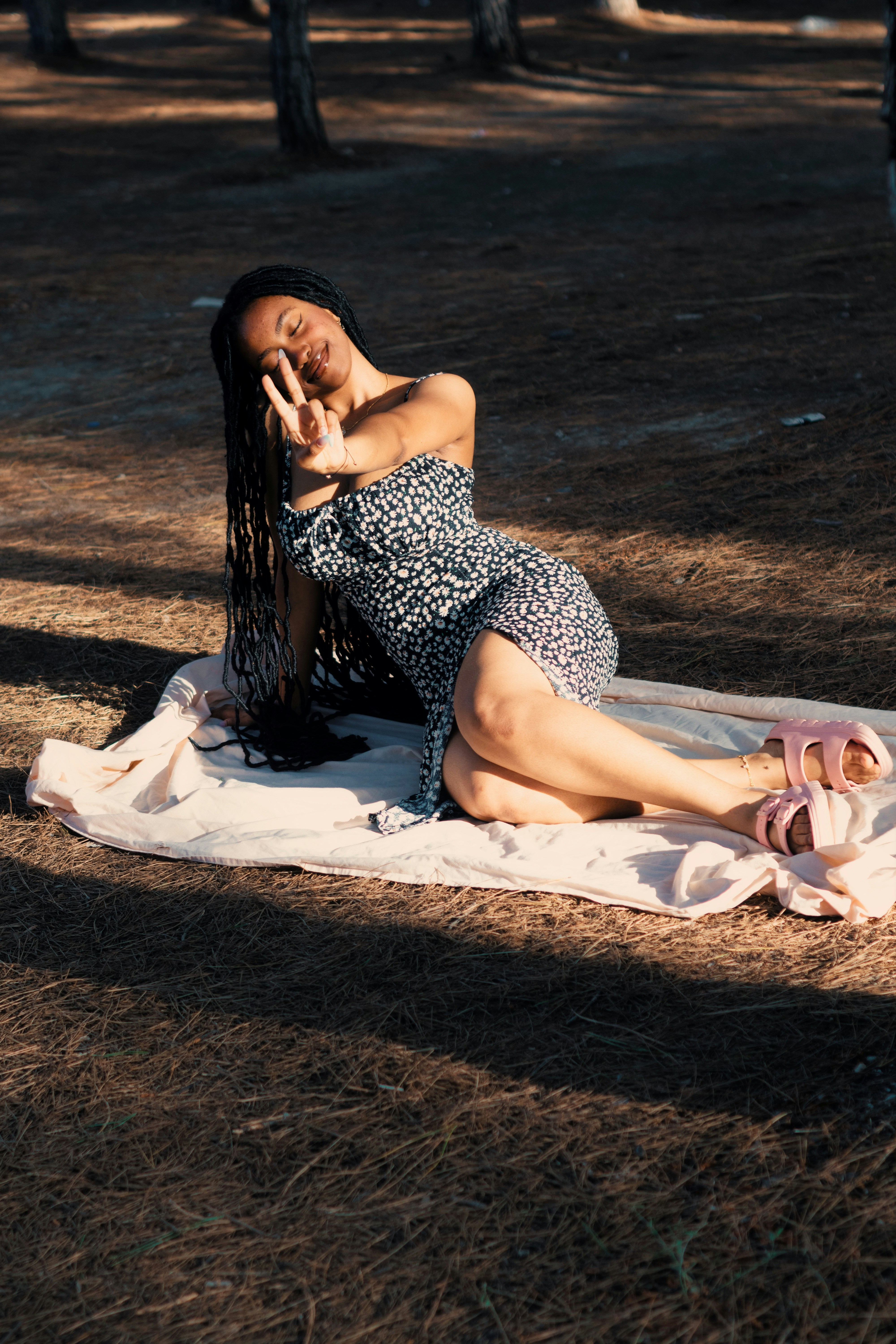 Woman posing on a blanket in a forest