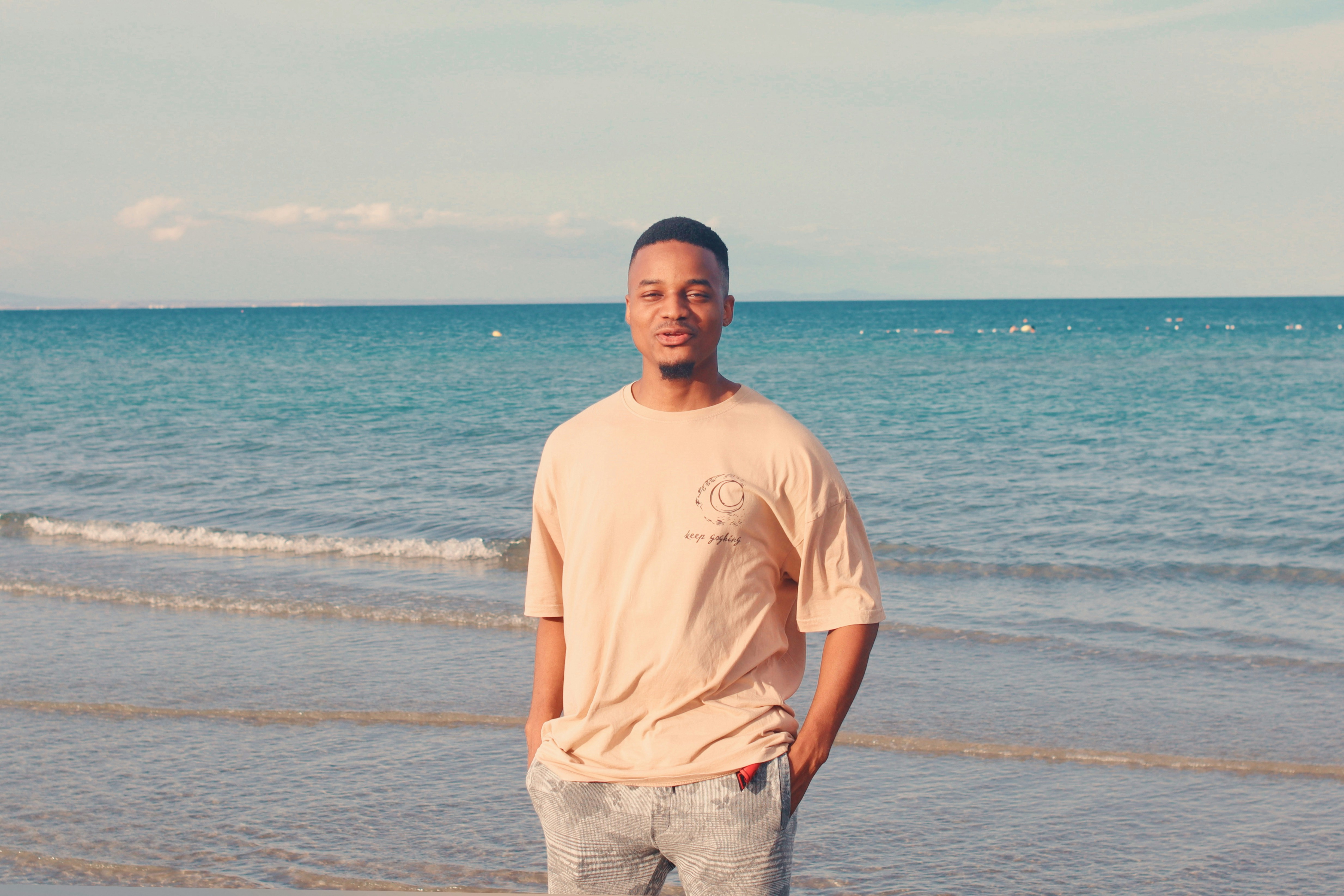 Man standing on a beach with ocean behind him