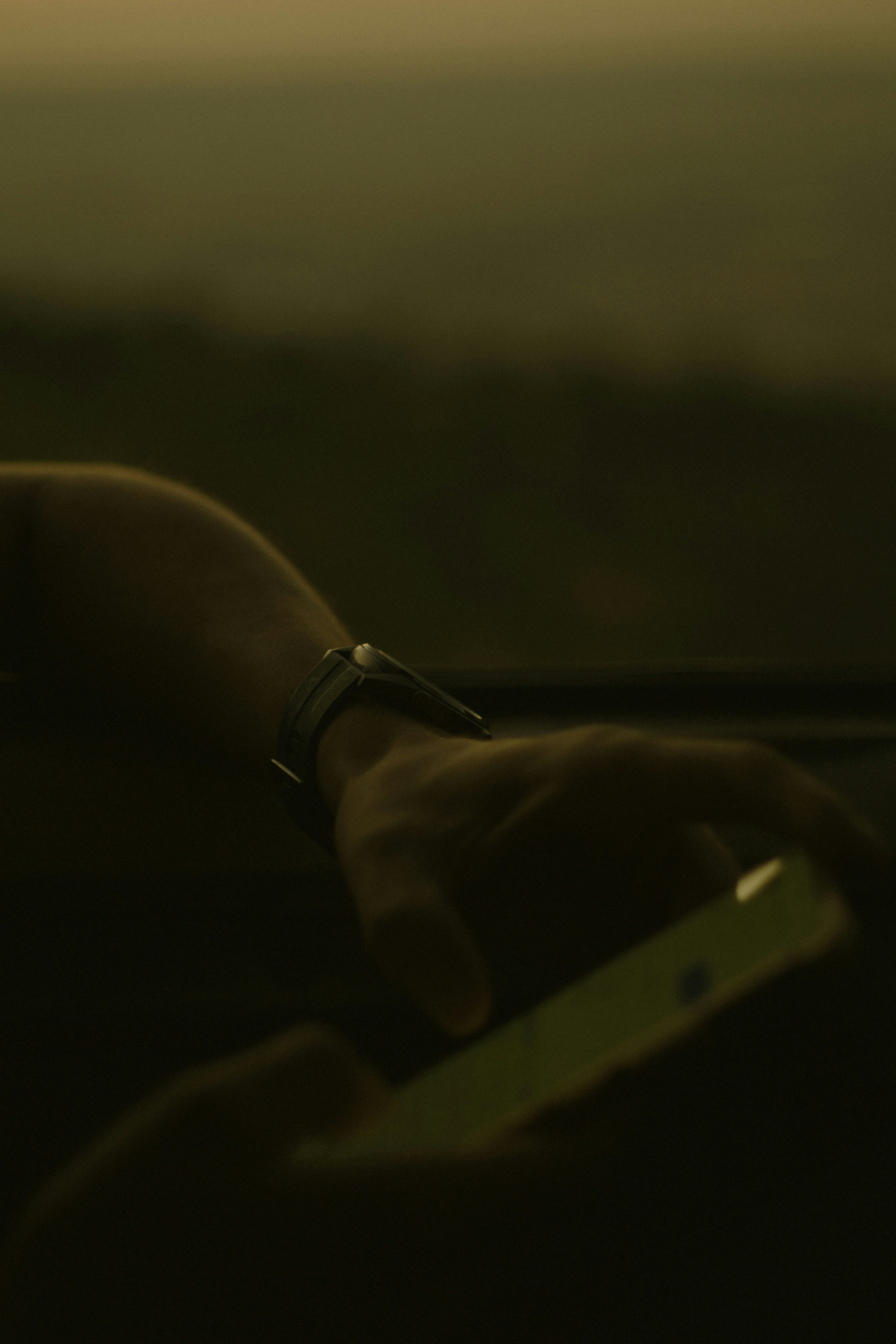 Person using smartphone inside a car