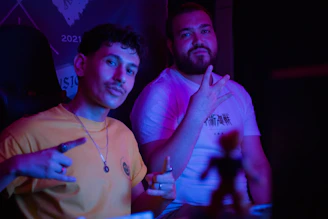 Two men posing for a picture indoors.