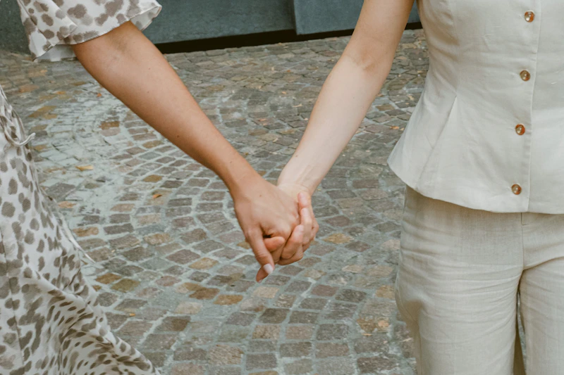 两人在鹅卵石小路上手牵手，浪漫温馨