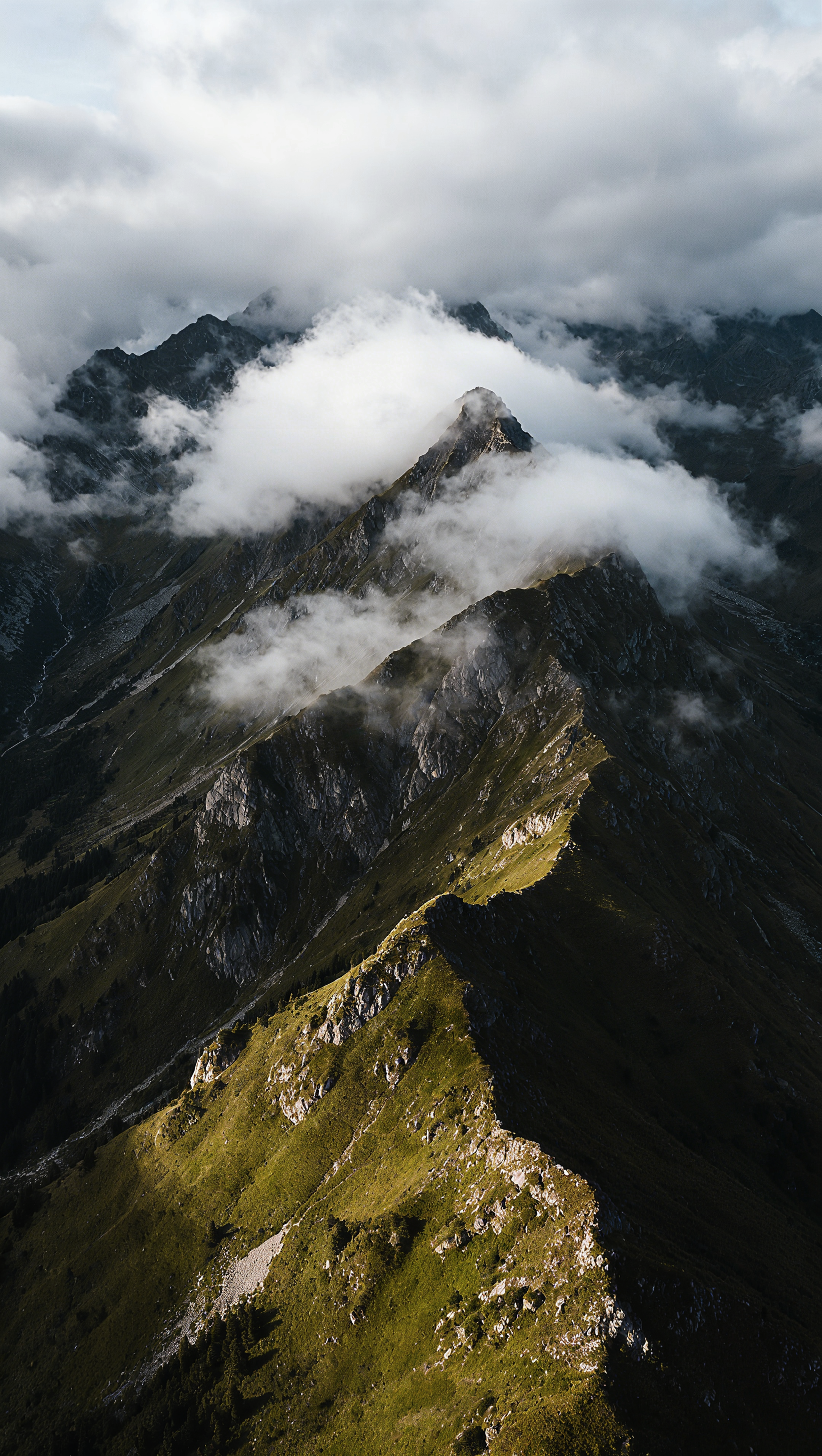Dramatische Bergkette, die in Wolken gehüllt ist