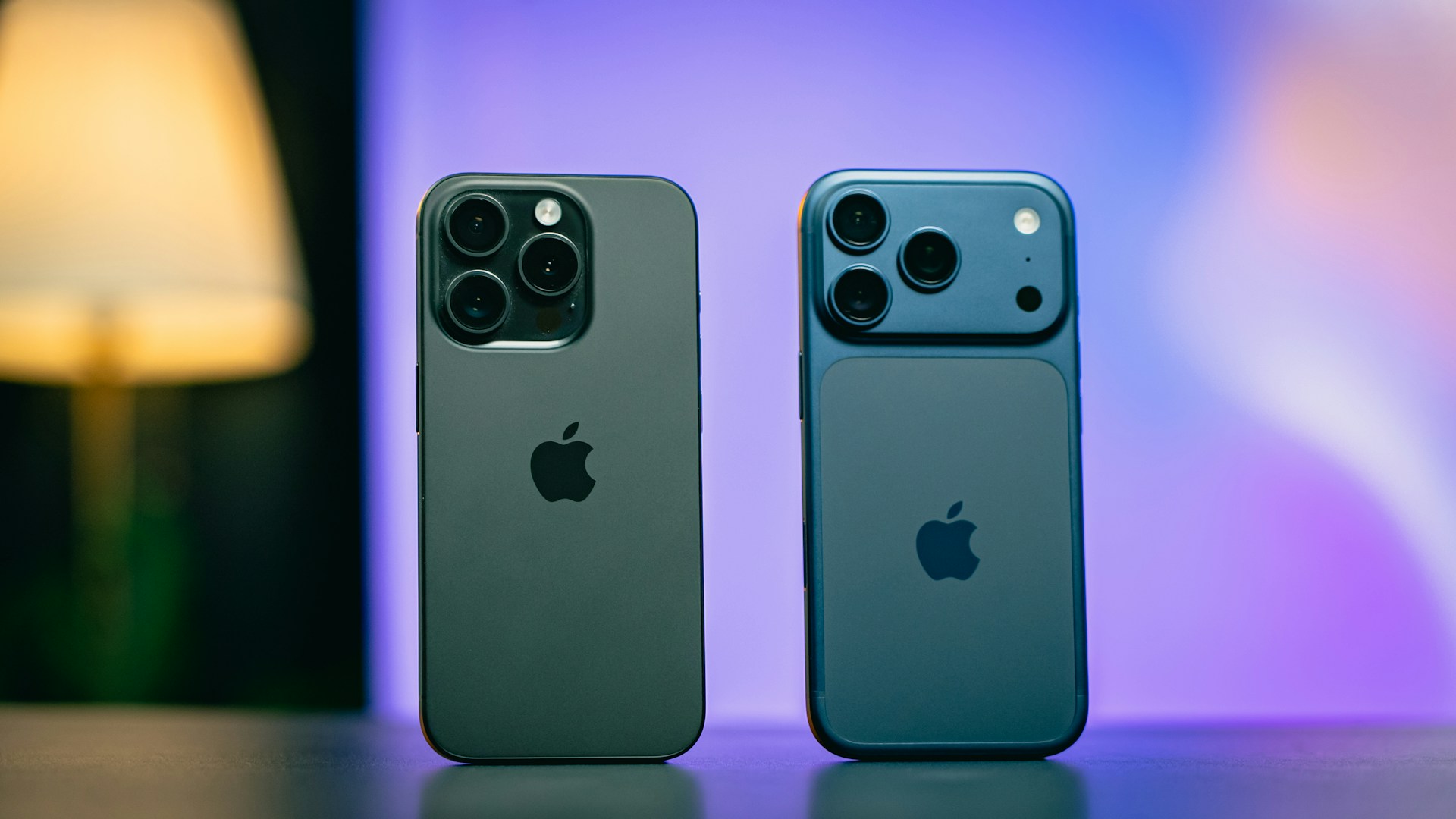 Two iphones side by side on a table.