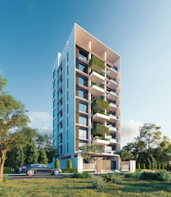 Modern apartment building with lush greenery and car.