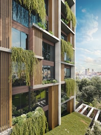 Modern building facade with lush hanging plants and balconies.
