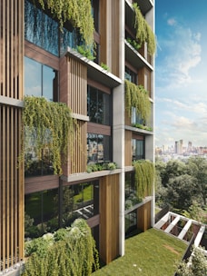 Modern building facade with lush hanging plants and balconies.