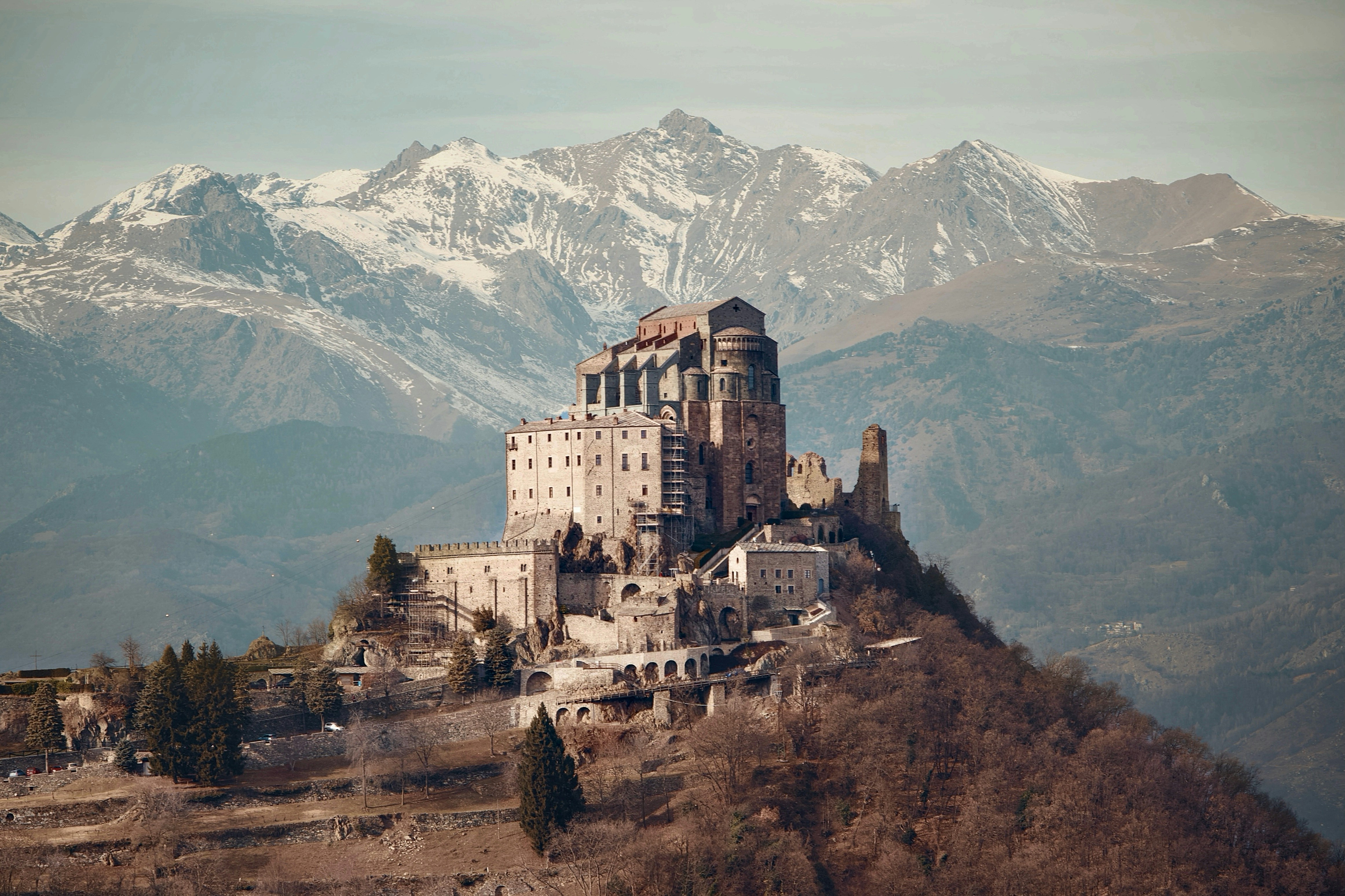 Ancient stone abbey perched on a mountain peak.