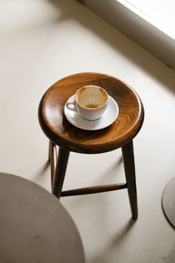 Empty espresso cup on a wooden stool