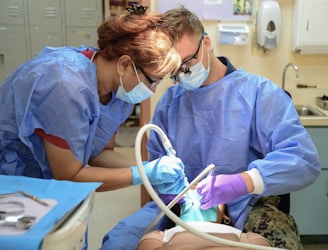 Dentists working on a patient's teeth