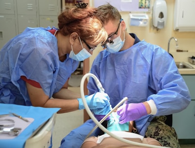 Dentists working on a patient's teeth
