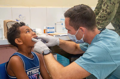 Dentist examines a young boy's teeth