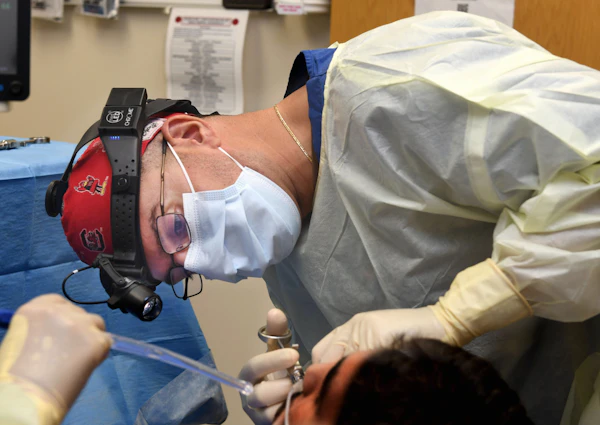 Surgeon dentist performing oral surgery procedure on patient