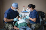 Dentists providing dental care to a patient.