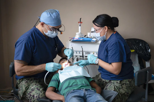 Dentists providing dental care to a patient.