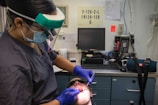 Dentist examining patient's teeth with tools.