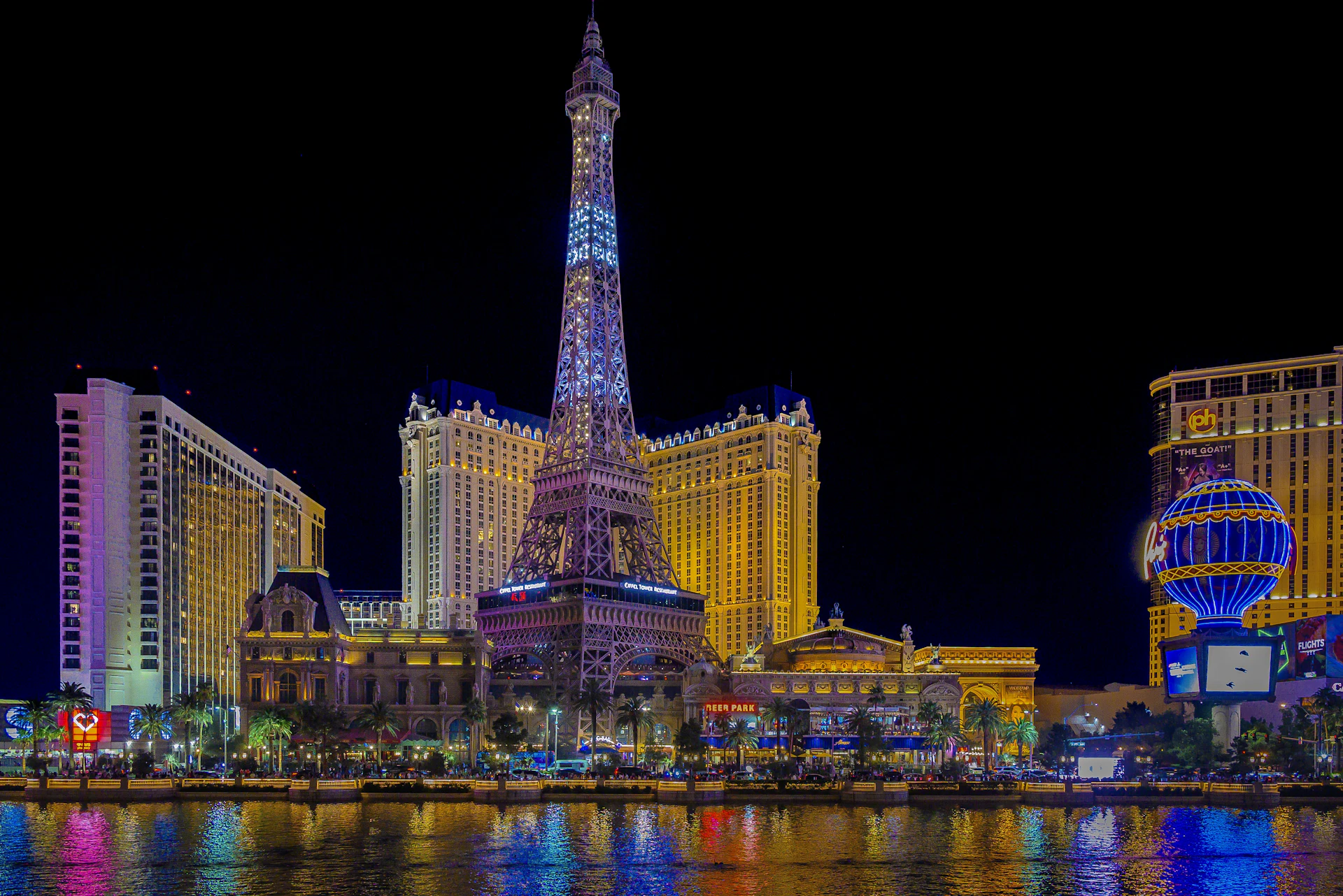 High Cardhaus casino hotel towers glowing above the city skyline at night