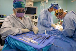 Surgeons operating with medical instruments laid out