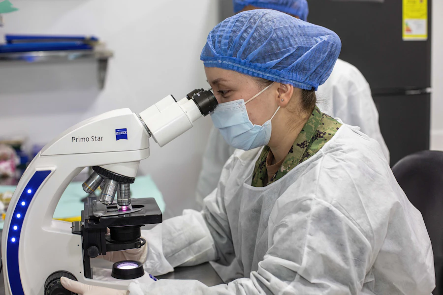 Laboratory technician looking through a microscope