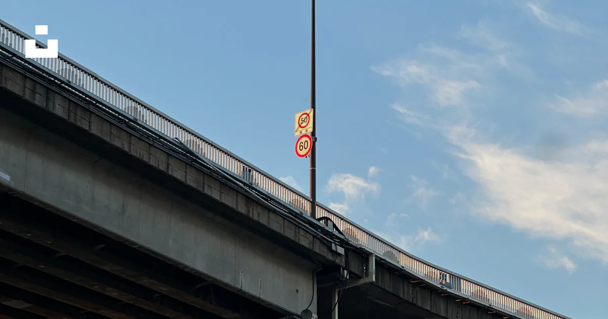 Overpass Signage A concrete overpass with a streetlight and signs. photo – Free ...