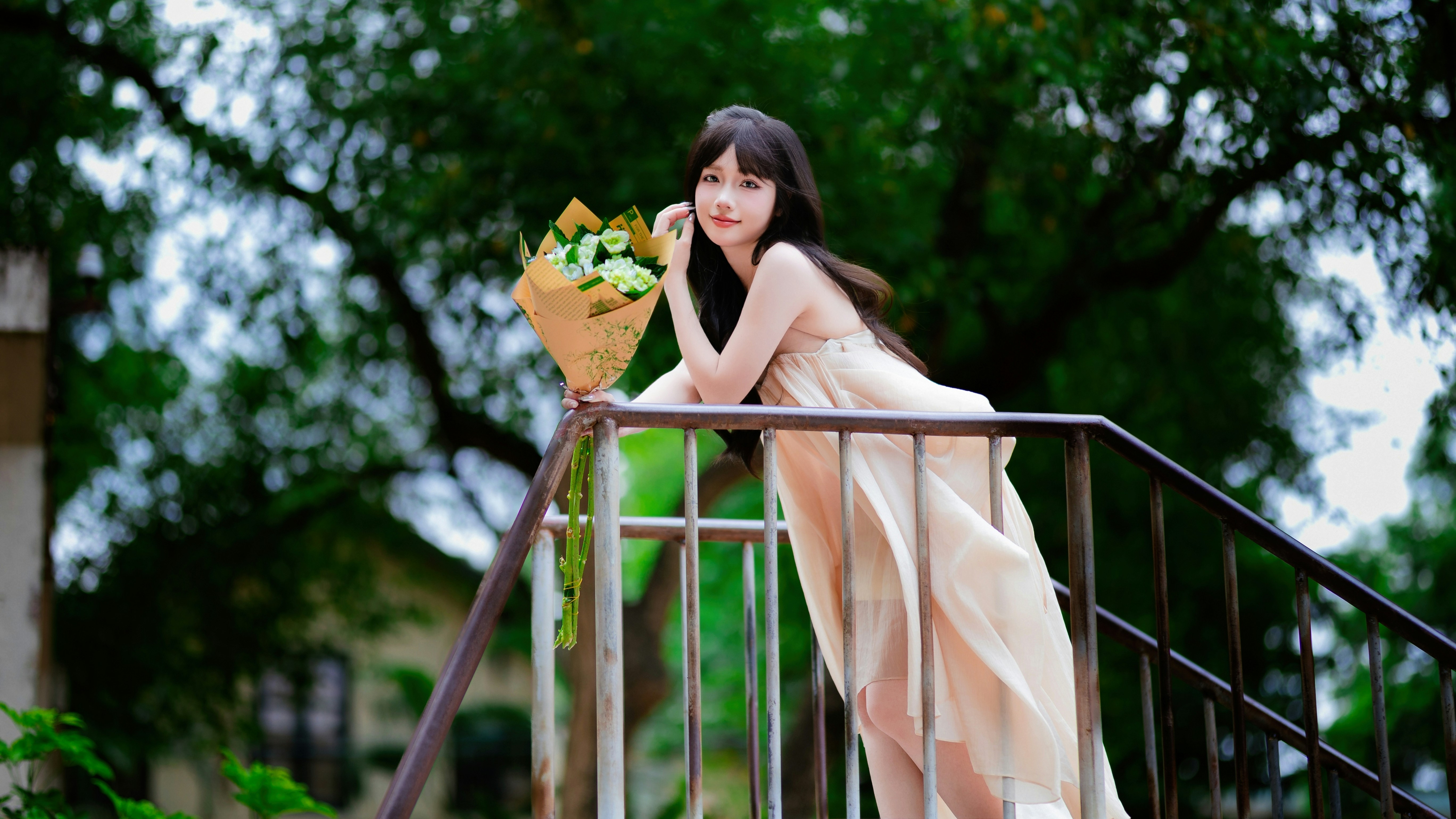 Woman in a long dress holding a bouquet of flowers