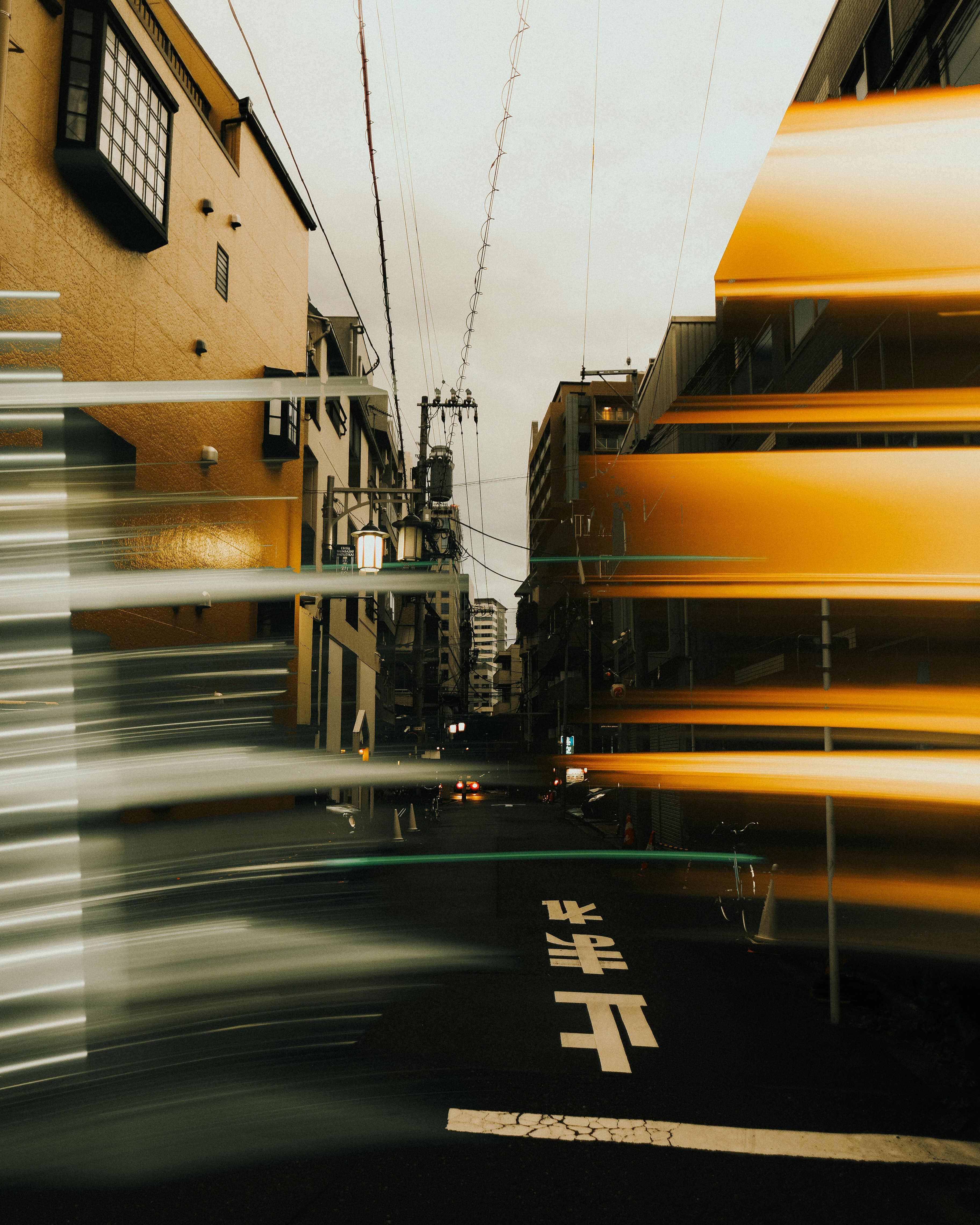 Street scene with motion blur effect at dusk.