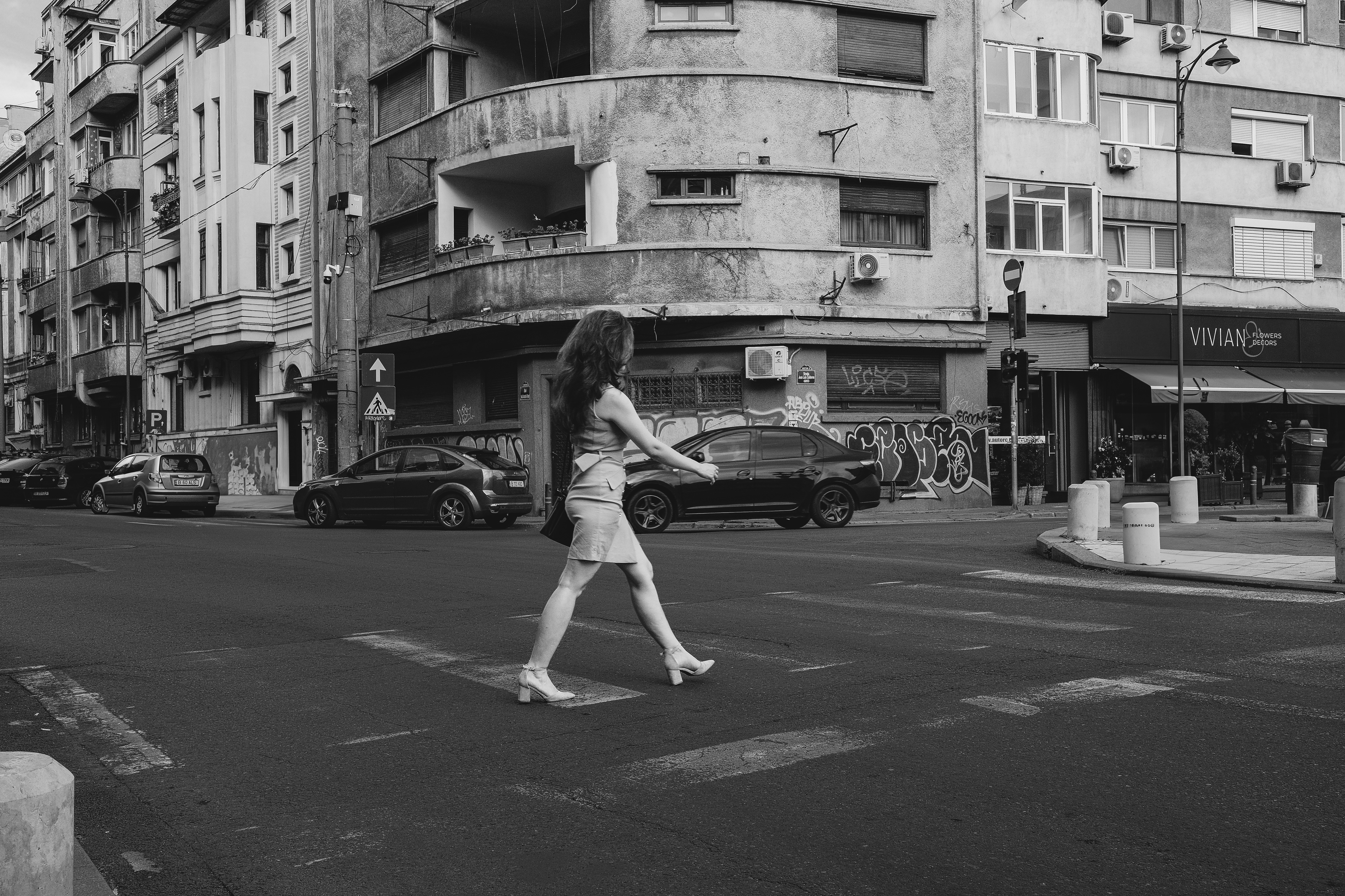 Woman crossing street in a city
