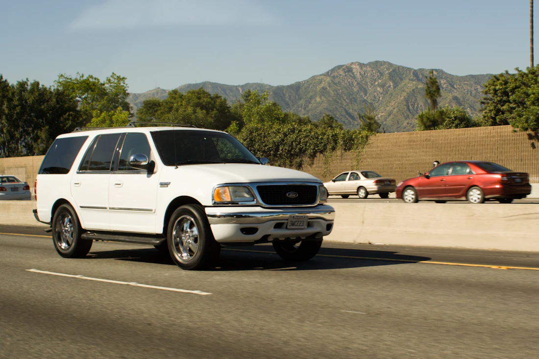 White SUV on a mountain highway