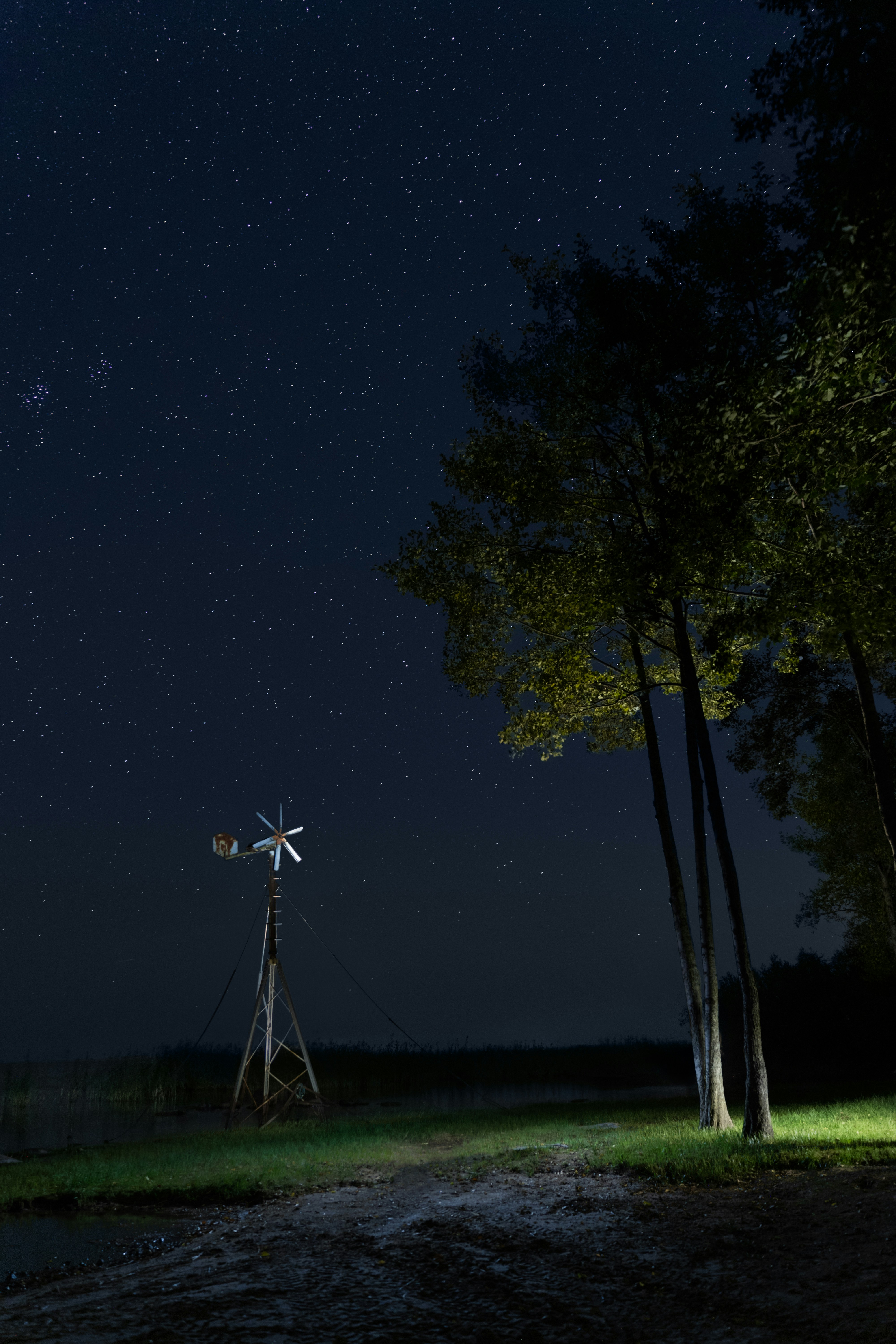 Windmill under a starry night sky
