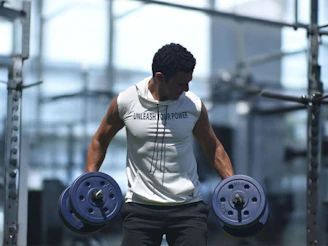 Man lifting dumbbells in a gym