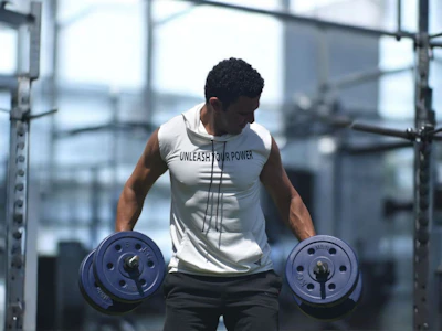 Man lifting dumbbells in a gym