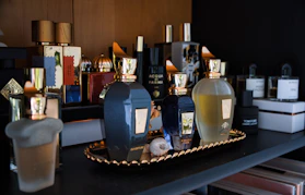 Collection of assorted perfume bottles on a shelf.